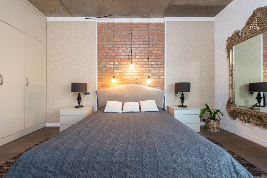 Small bedroom ideas with a bed, side stools and wall lights