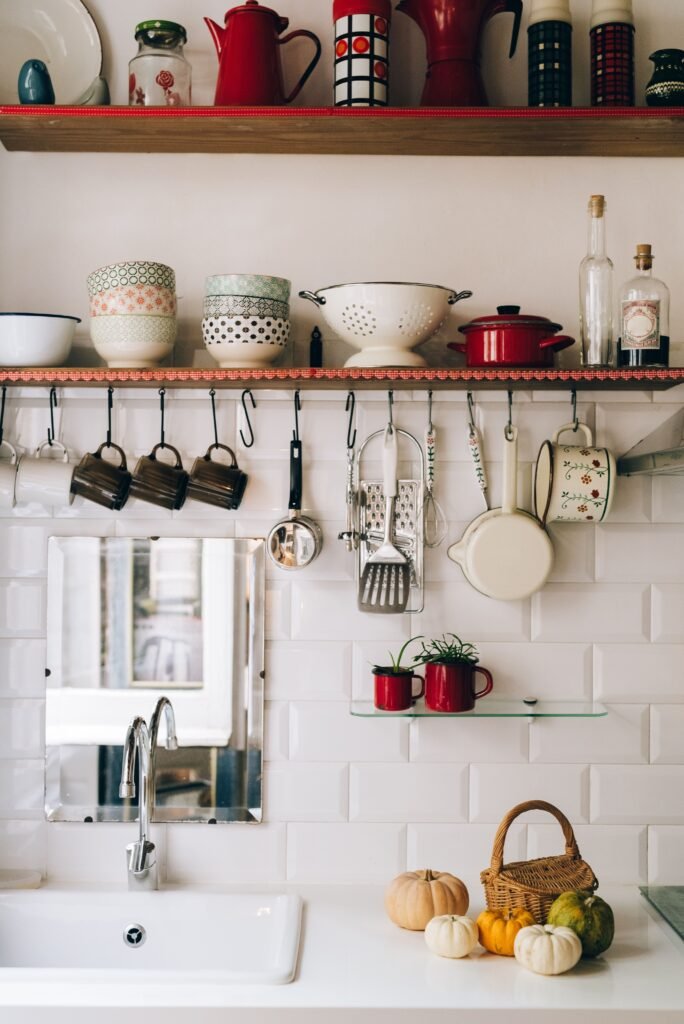 Kitchen with hanging utensils, wall shelf and cookware