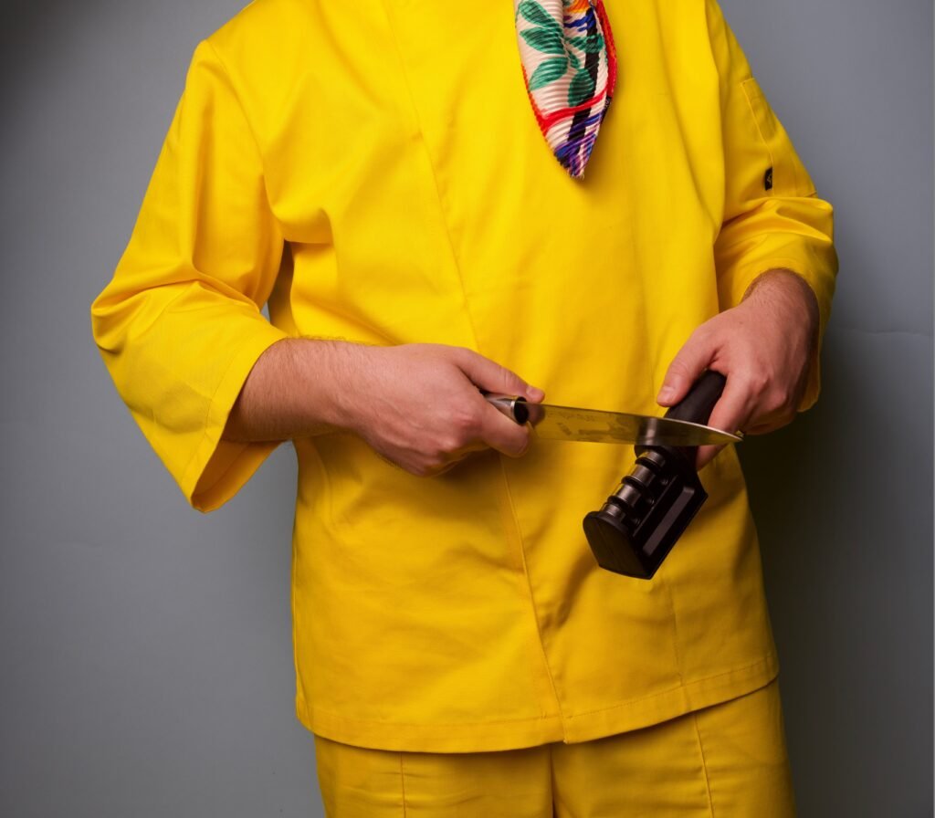Person sharpening a kitchen knife with a knife sharpener