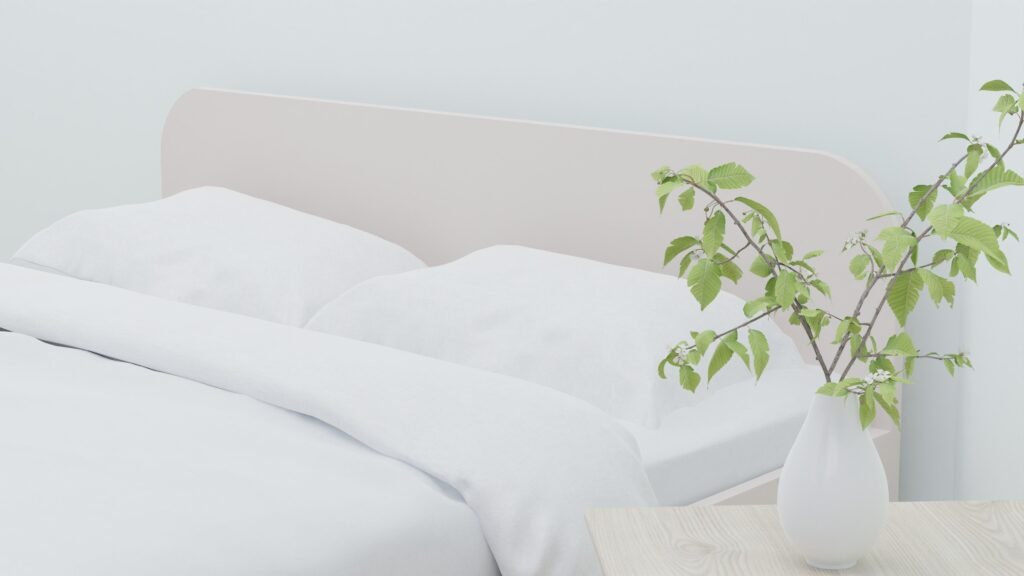 White comforter on a bed with two pillows