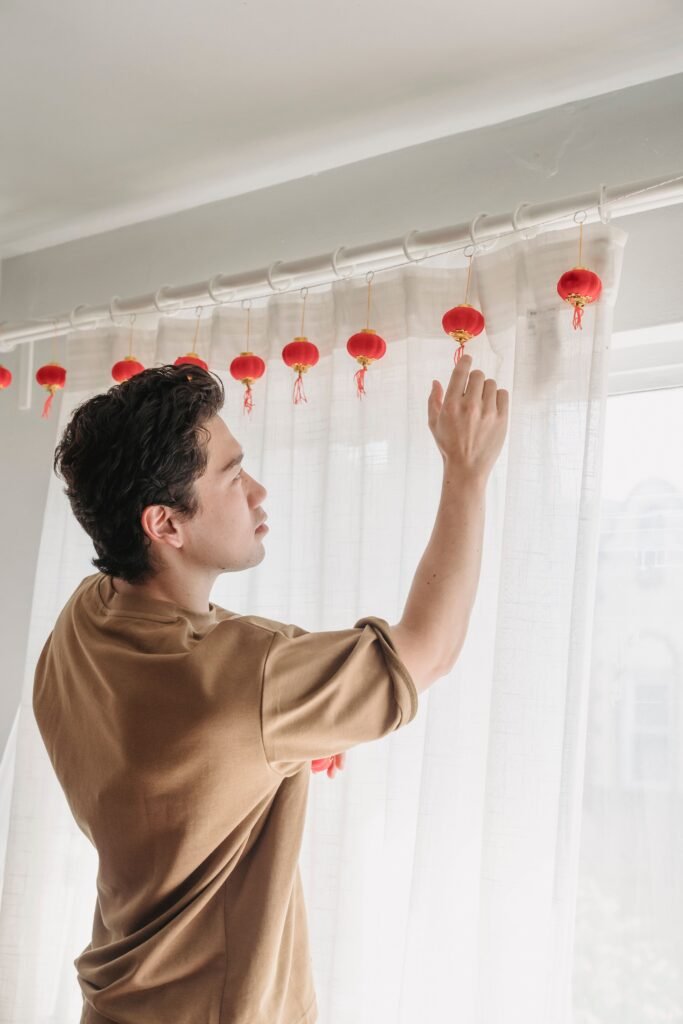 Person installing curtain rings