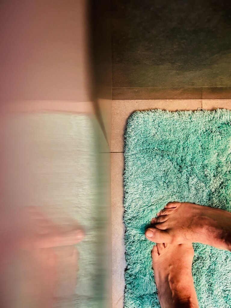 Bathroom rug with feet standing on it