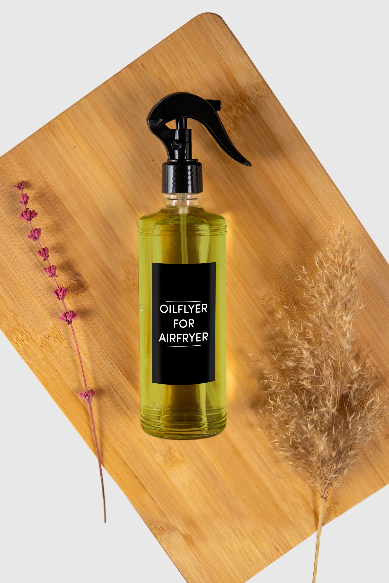 Glass olive oil sprayer on a kitchen platter
