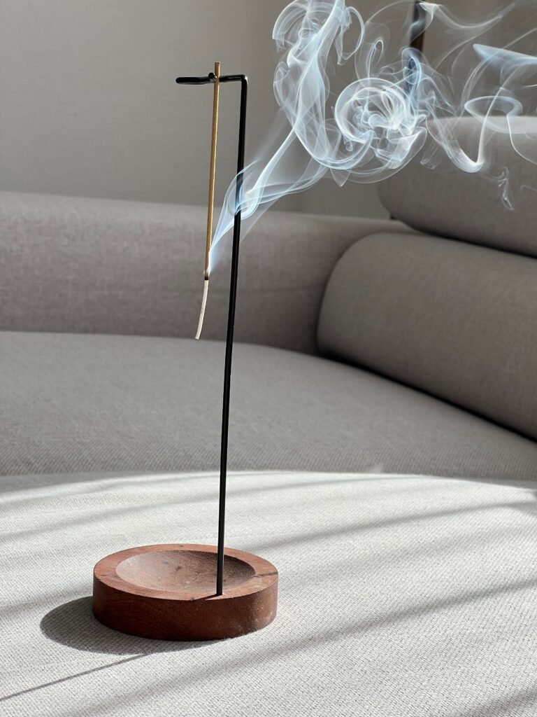 Wooden incense holder with a burning incense stick